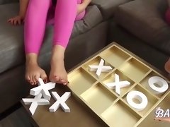 two women play x and 0 with very sexy feet