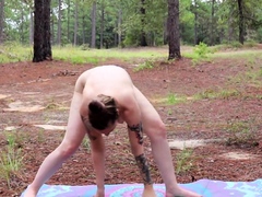 Big breasted young brunette doing naked yoga in the woods